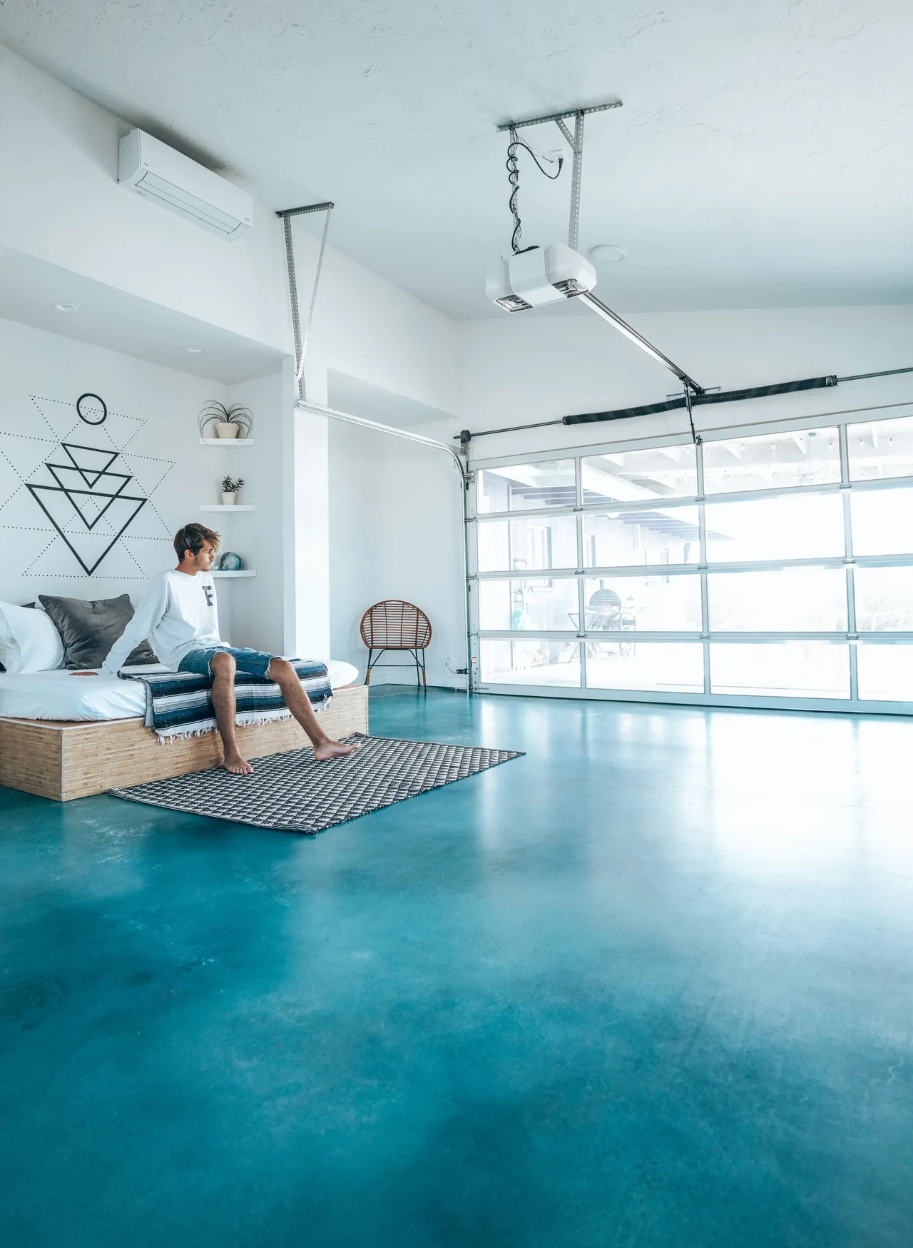 Glossy blue decorative floor in an interior with a sofa and storage cabinets